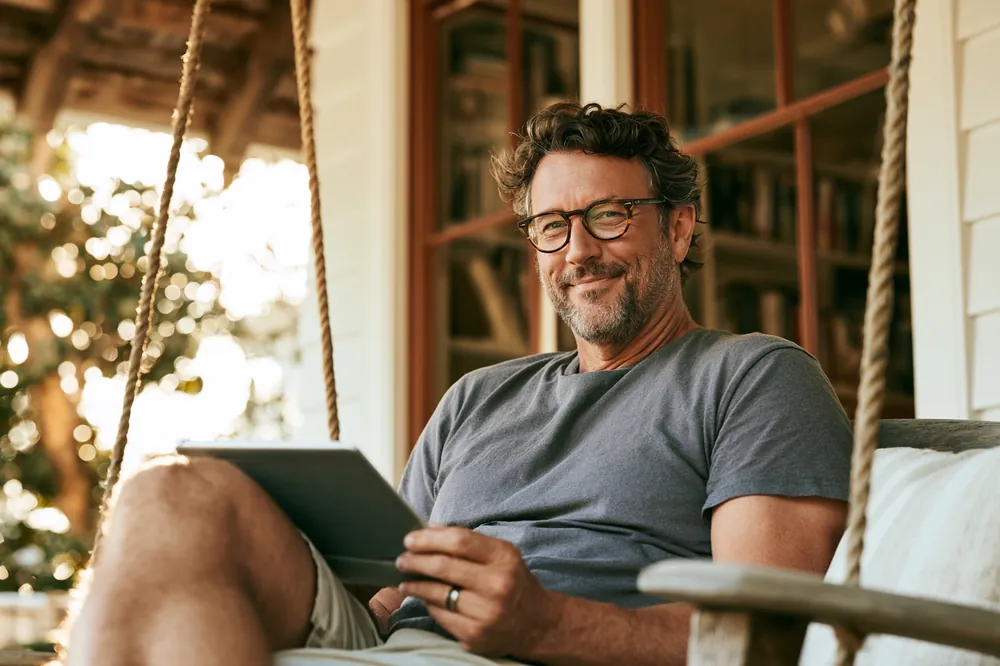 Satisfied BHG Loan customer reading his loan statement at home
